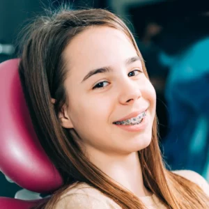 young female patient smiling with braces at a dentistry in Waco, TX.